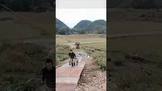 A wheelbarrow hauls bricks up a steep slope