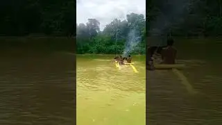 Boys Paddling Raft Across Mighty Purari River to the other side