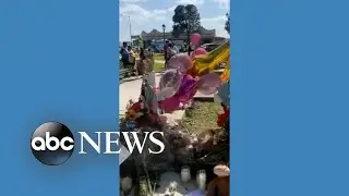 Flowers and crosses placed in Uvalde town square memorial