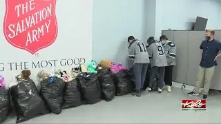 Stampede players deliver donated teddy bears on Thursday