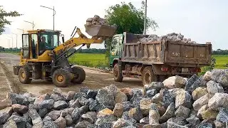 Launching a new project, a Komatsu excavator is digging earth and rock to reinforce the riverbank.