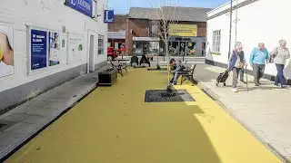 Residents slam bright yellow 'custard corner' painted in historic market town | SWNS