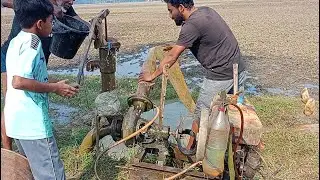 Antic style lifting water and 16hp shelo machine start.Village men try to start 16hp diesel engine.