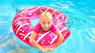 Kids and large inflatable toys in the pool