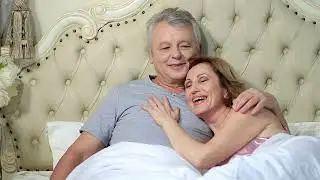 Older couple hugging in bed