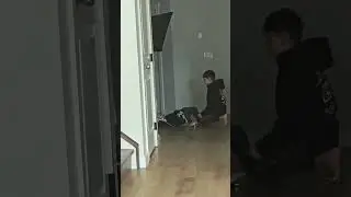 OLDER BROTHER HELPING THE BABY GET DRESSED