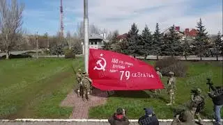 True Face of Putins Soviet Modor: Russian Soldiers hoist the Soviet Victory Banner in Kherson