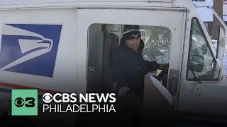 USPS letter carrier on his route in Huntingdon Valley, Pennsylvania despite frigid temperatures
