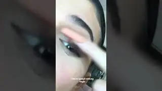 Kylie applying eyeshadow with her finger