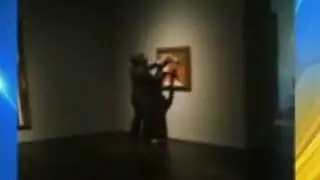 Man captured on a cell phone spray painting a Picasso