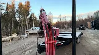Moving equipment trailer out of shipping container building