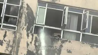 Fire engines spraying water into a burning Delhi high-rise building