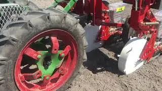 3-row Jang seeder on electric Planet Jr walk-behind tractor