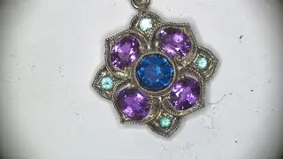 Pave` setting of oval Amethysts and Paraibas with blue Gahnite center