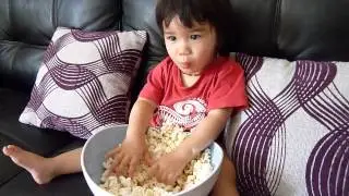 17 months old baby eating popcorn for the first time