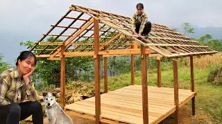 The young girl built a two-story wooden house in the forest. The roofing process.