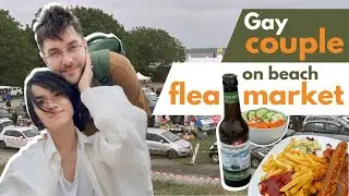 International gay couple goes treasure hunting on beach flea market