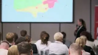 Business presentation with audience focusing on a colorful displayed chart
