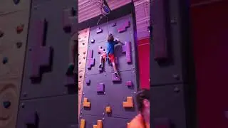 Little Boy Climbs On Rock Wall And Rings the Victory Bell - 1197223-2