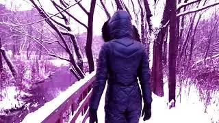 WINTER WALKS IN A NAVY BLUE SHINING SKI OVERALL WITH A WHITE FUR PILLOW, A BLACK + GAS MASK
