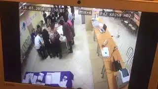 An election worker in Russia places balloons in front of a camera before they begin ballot counting