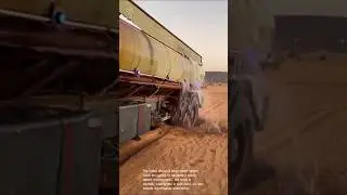 Desert tanker truck stuck in sand: water truck struggles