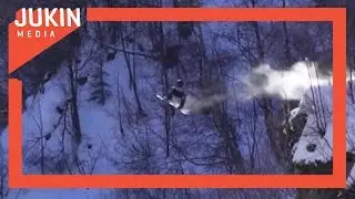 Snowboarders Jump Over Road Gap