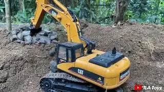 RC Excavator Lowering Rocks and dredging soil for Fish Pond Development Project