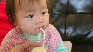 Baby Lee drinking milk with straw