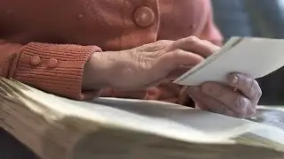 Elderly Woman Looks At Photos Stock Video