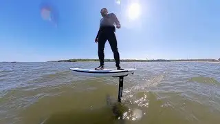 Riding a hoverboard over the water.