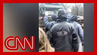 'We are unarmed!': Civilians stare down Russian military convoy