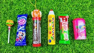 Satisfying video Asrm sound opening a box of lollipop, chewing gum and chocolate candy.
