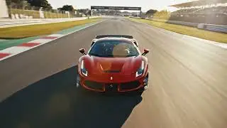 The Ferrari flips multiple times and skids to a stop on the track.