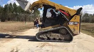 Cat 259D skid steer spreading gravel