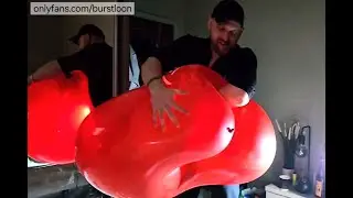 Tom pops a Qualatex 36 inch heart balloon