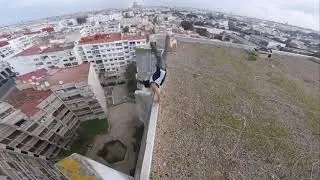 Daredevil Performs Insane Stunts on the Ledge of a Building