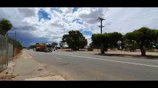 Volvo semi with lowboy dropdeck hauling oversize load Cat caterpillar mining off highway truck