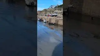 INCOMING TIDE AT PORTREATH HARBOUR IN CORNWALL.