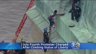 July 4th Protester Charged After Climbing Statue Of Liberty In Protest Of Immigration Policy