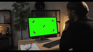 Businessman working on computer with green screen footage with tracking markers