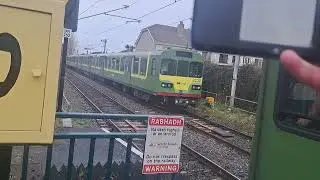 2 dart trains arrive and departs Kilbarrack for Malahide and Bray