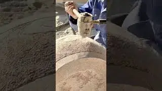 Close-up of a Mallet Striking Stone to Carve Detailed Texture or Finish