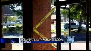 Local woman walks through bank window