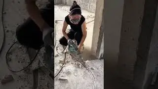 Worker Jackhammering Concrete Floor Marked for Demolition and Repair