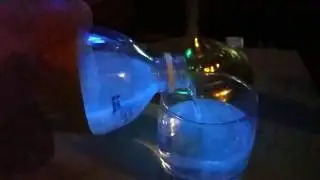 Slow motion tonic water under a black light