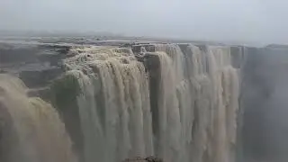 a natural geographical feature where water flows over a steep drop, and a type