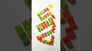 #Greedy #Pacman chomps red, green & yellow jelly cubes arranged like a colorful candy snake