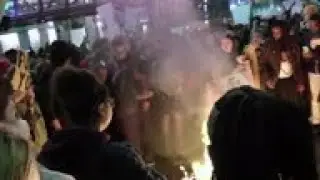Protesters burn Trump hats outside rally