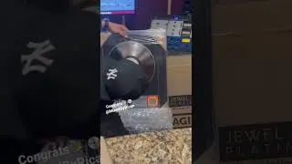 MixedByRican unwrapping platinum plaque at Audio Nerdz recording studio.
